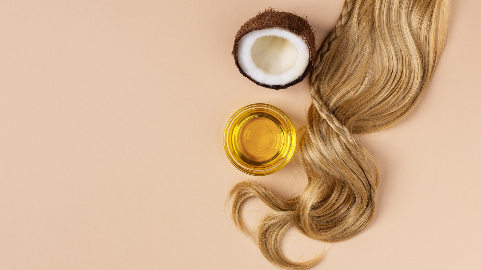 Blonde hair strands, coconut, and glass bowl of oil - ingredients for DIY hair masks